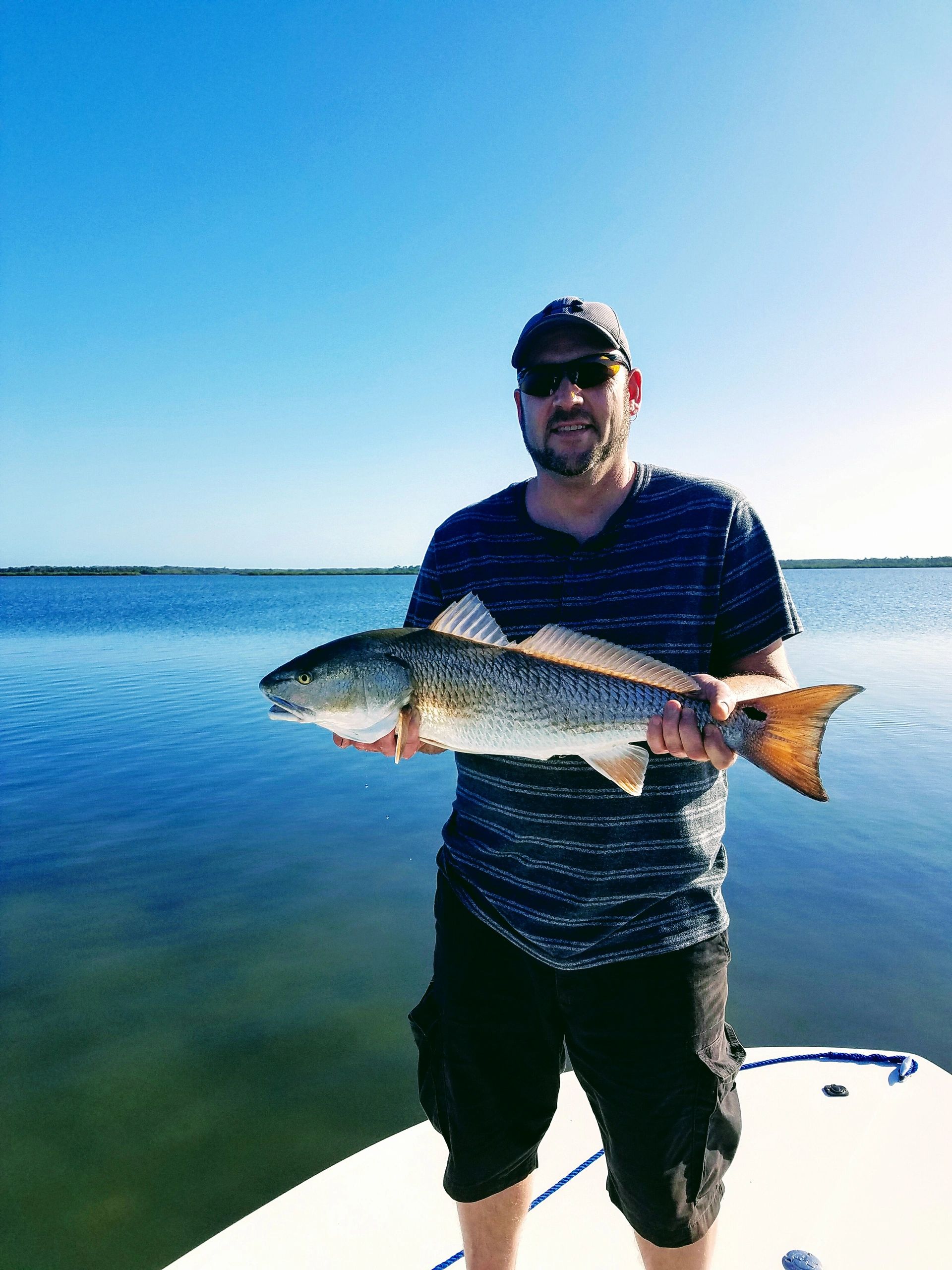 Client with one of his redfish caught topwater fishing during an inshore charter